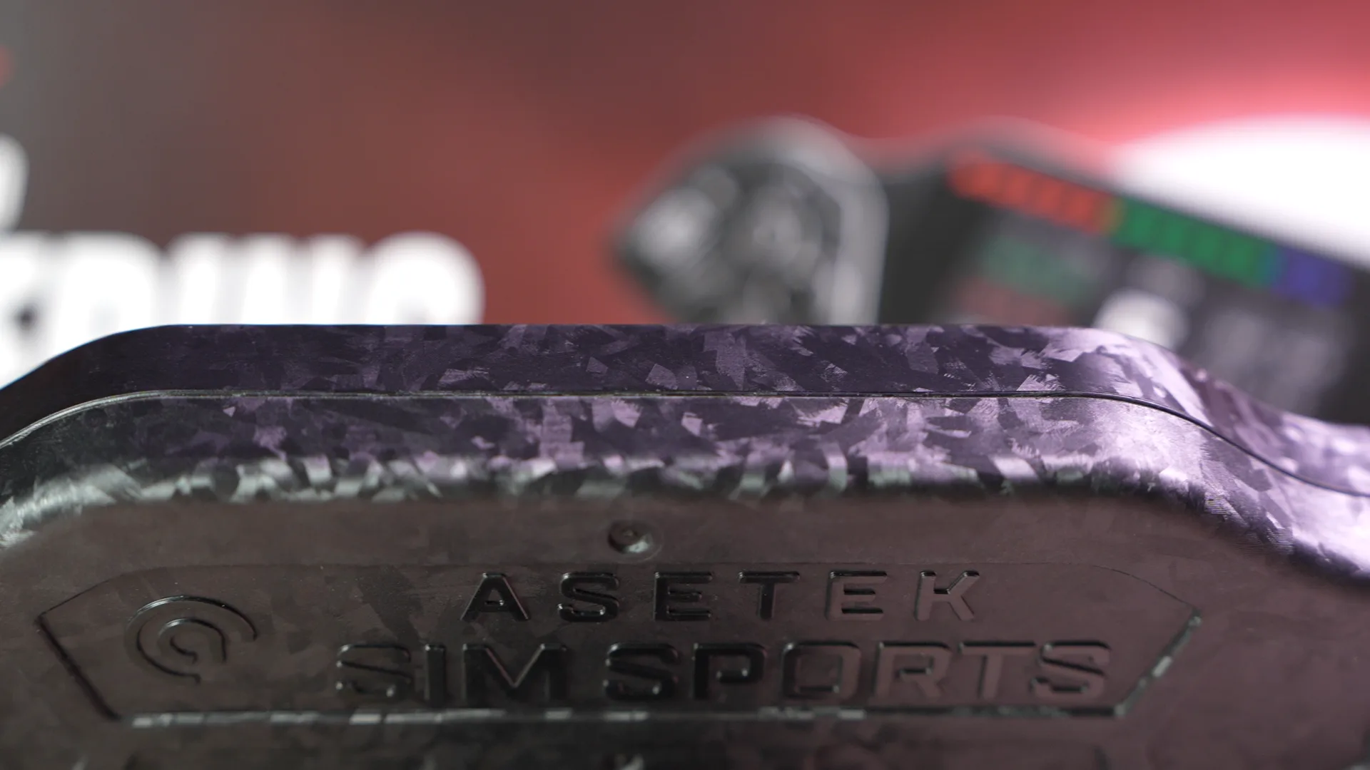 La gravure Asetek SimSports dans le carbone forgé, en macro